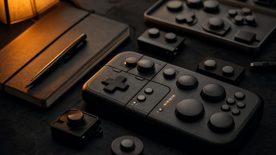 A close-up of a modular customisable controller with large swappable buttons on a dark desk